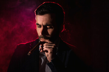 Photo of smoking man on pink background.