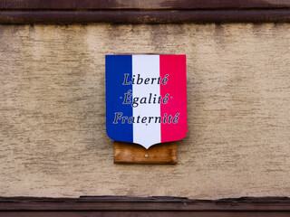 Colmar, France - March 27, 2022: Coat of arms in the colors of the French flag with the motto of...
