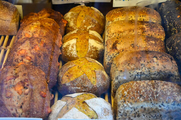 Fresh pastries on display in the bakery. French pastry. Bread, muffins, sweets, pies and cakes.