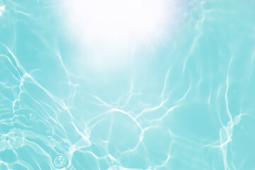 Defocus blurred transparent blue colored clear calm water surface texture with splashes and bubbles. Trendy abstract nature background. Water waves in sunlight with copy space. Blue watercolor shining