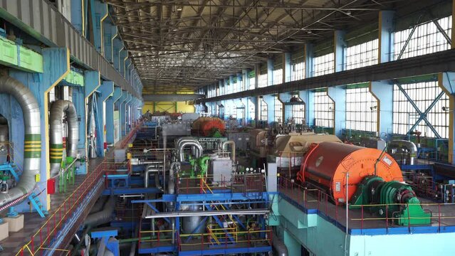 Inside a huge thermal power station, view of pipes and turbines, energy conversion system, environmental issues, power generation system, engineering structure.