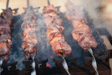 Appetizing pieces of meat are fried on the grill....
