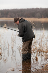 fisherman stands in the water and catches fish....