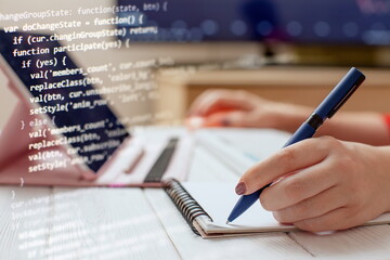 Woman programmer write down code on paper