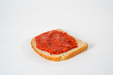 Top view of tomato sauce on a slice of bread isolated on white background with text area.