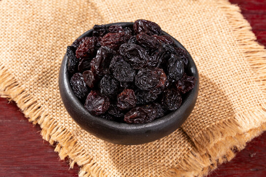 Healthy Food - Nuts Dehydrated Grapes; Photo On Wooden Background