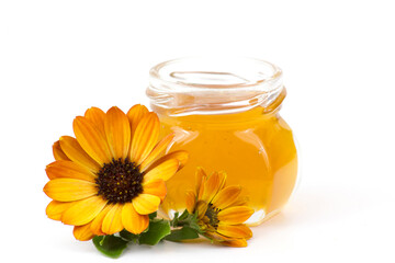 honey and flowers on white background