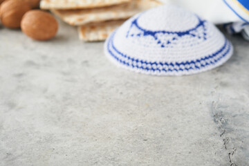 Passover celebration concept blurred focus. Traditional ritual Jewish bread matzah, kippah and...