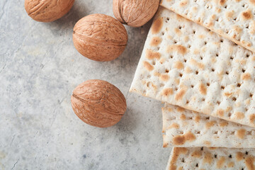 Passover celebration concept. Matzah, red kosher and walnut. Traditional ritual Jewish bread...