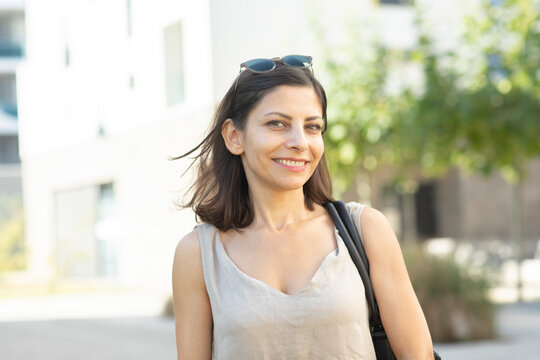 Portrait of smiling mid adult woman standing outdoors