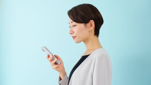 スマートフォンを使う若い女性　ビジネスイメージ	