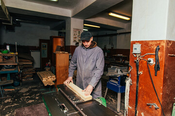 Work on woodworking machines and saws in a furniture workshop