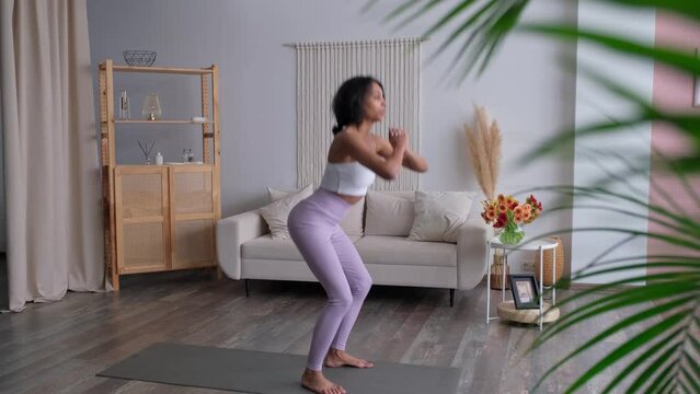 Footage of african american woman exercising at home. Healthy body,mind and lifestyle. Self care. Wellness,welbeing