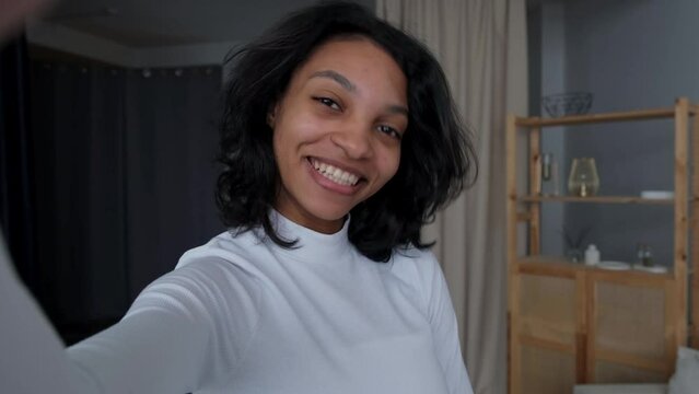 Closeup footage of black happy girl ralking on video call or streaming on social media without make up.Every day life. Self care and self acceptance.Change beauty standards