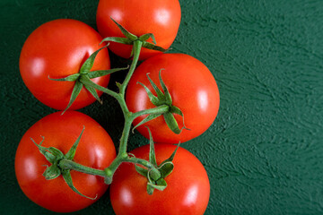 A group of grape tomatoes on a green background,top view