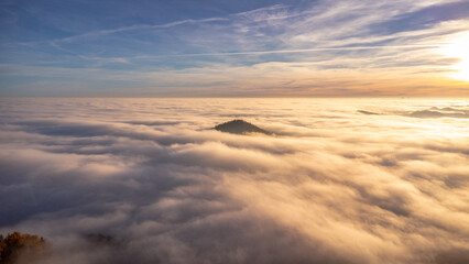 Beautiful sunset with an inversion that looks like a flowing sea. Sunset in autumn under Jested. Photographed by drone