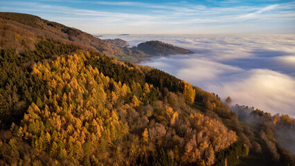 Beautiful sunset with an inversion that looks like a flowing sea. Colorful trees in autumn. Sunset...