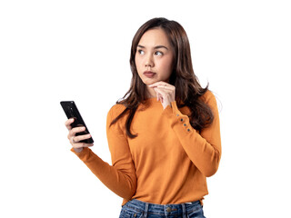 Fototapeta premium Photo features a happy Indonesian woman wearing an orange sweater and jeans while holding a smartphone, isolated on a white background.