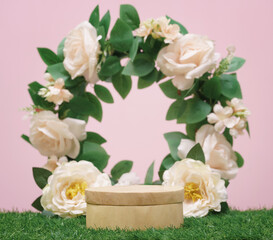 wood podium beige rose flowers on pink pastel background with space.beauty cosmetic skin care...