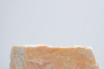 empty natural rough beige granite stone podium on white background with blank space.cosmetic beauty fashion product present placement pedestal promotion display,mock up minimal concept.