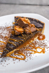 Dark chocolate and caramel cake on a plate