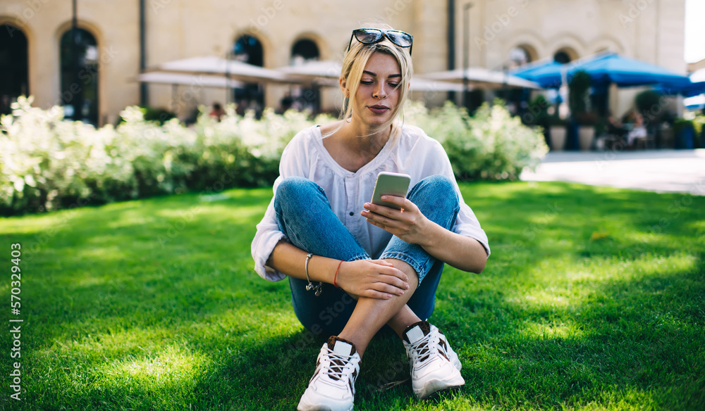 Aufkleber young caucasian woman using cellular application for web networking in social media during leisure i