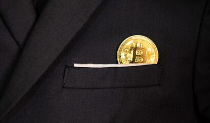 bitcoin in a business man black suit pocket, a concept of future investment and block chain technology