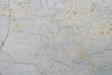 Rough textured surface of an old cracked concrete wall with selective focus on the center. Backdrop