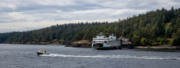 A Washington State Ferry unloading cars at Lopez Island ferry dock in the San Juan Islands as a...