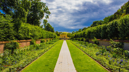 Dramatic sky over symmetry garden in park Pildammsmarken in Malmö Sweden during summer