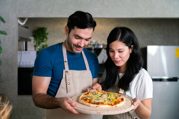homemade italian pizza dough face with vegetable and sauce cook by couple love chef at home on table in modern kitchen, happy family moment together