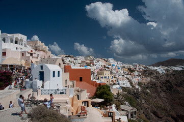 View of the island of Santorini, Greece. Houses on the mountain. People take photo. Santorini, Greese, 21.09.2011