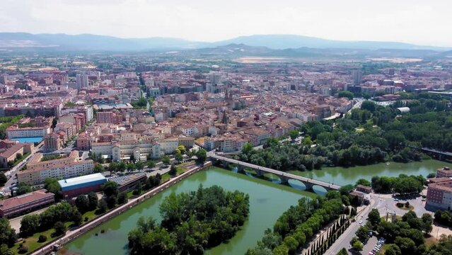 Aerial point of view of Logrono city. View of Ebro River and Puente de Piedra bridge. In background is the city center of Logrono. Drone truck left and right pan. Beautiful panoramic of all region