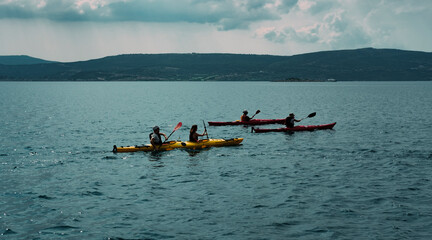 Messinia, Navarino Bay, Greece - 19 June 2022 : Canoe instructor or kayak water sportsman in water,...