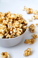 Caramel popcorn in a bowl, on a white background
