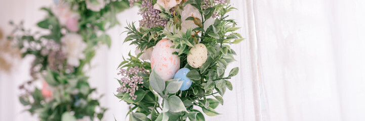 happy easter and spring holidays time. easter wreath with sprigs of lilac bush blossom flowers and...
