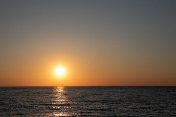 Fototapeta na wymiar sea sunset bright sun nature calm beach holiday