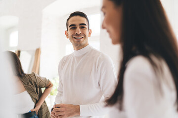 Fototapeta premium Cheerful multiethnic colleagues communicating during break in office