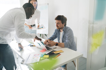 Focused diverse colleagues working on project in office