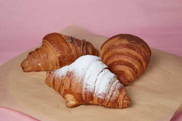 fresh croissants on table, dessert with powdered sugar and fruit filling, monochromatic background, close-up