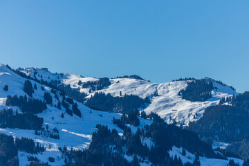 Bright sunlight  over snow covered mountains in the Austrian Alps - Ski resort Ktizbühel, Tirol
