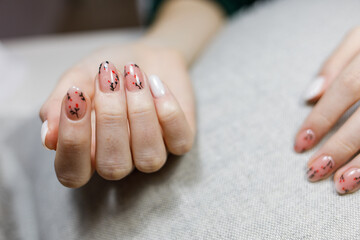 Top view woman's hands manicure with nail painting work.Professional manicure with gel polish in beauty salon. 