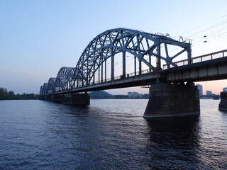 Fototapeta na wymiar The railway bridge across the river Daugava in Riga