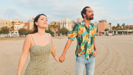 Couple in love walking on the beach hugging each other