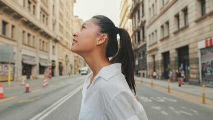 Young woman crossing the road at crosswalk