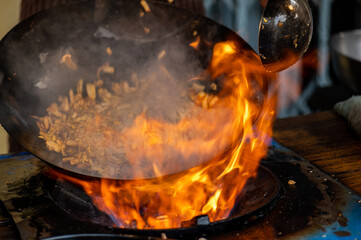 Pad Thai favorite and famous Asian Thai street fast food in hot pan, Pad Thai is stir fried rice noodle dish commonly served as a street food and at casual local eateries in Thailand