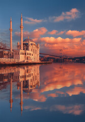 Ortakoy Mosque near Bosphorus in Istanbul, Turkey. Mosque on the background of sunset. Reflection in the water.