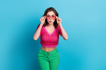 Portrait of gorgeous adorable pretty woman with wavy hairstyle wear knit top hands touching glasses isolated on blue color background