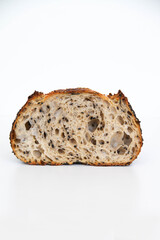 Sliced sourdough bread with black sesame seeds, white background
