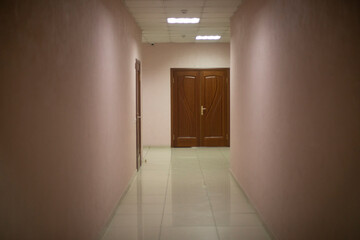 Corridor in building. Door at end of corridor. Interior details.